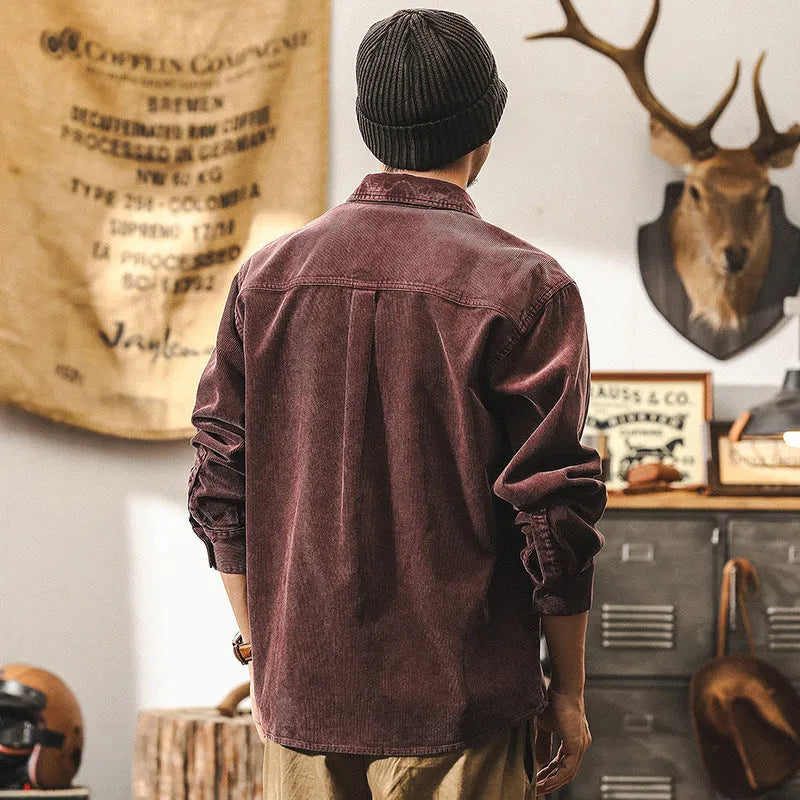 Men's loose-fit long-sleeved corduroy shirt jacket in black or red, showing textured combed cotton fabric.