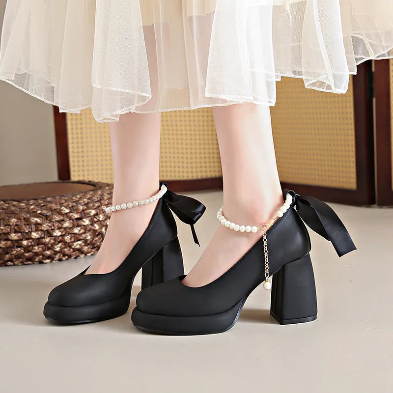 Beige women's Mary Jane shoes with a chunky heel, round toe, and an ankle-strap buckle.