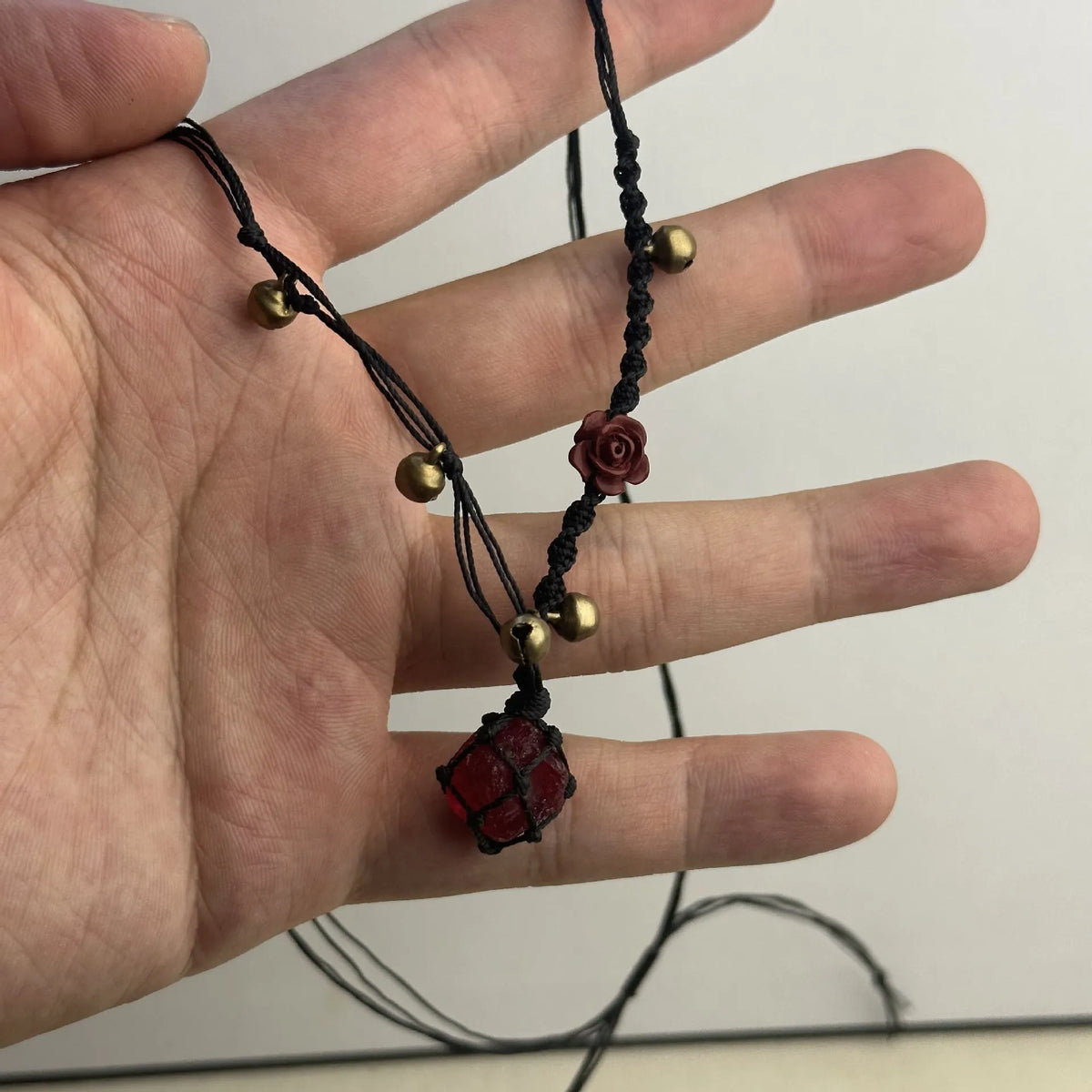 Artificial crystal rough labradorite-style pendant necklace with O-link chain on display