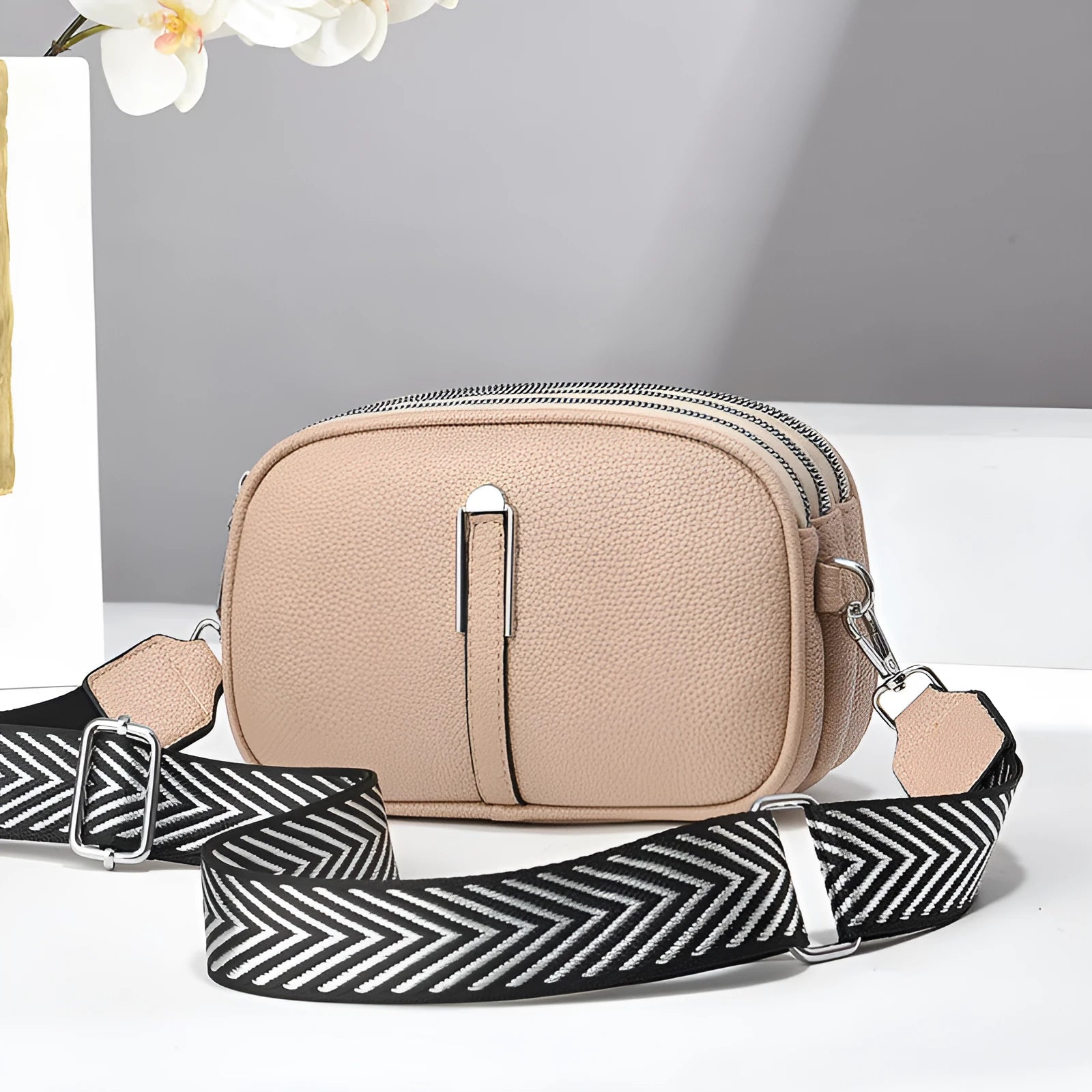Women's soft PU crossbody bag in oval shape with interior organisation compartments