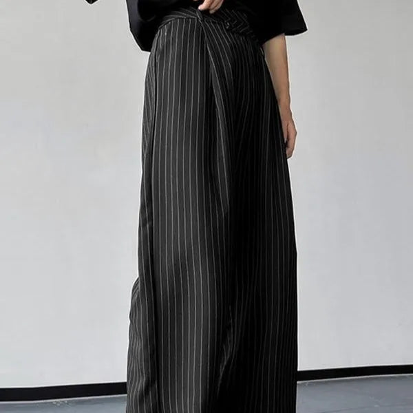 Man wearing black vertical striped pleated casual trousers with an elasticated waistband.