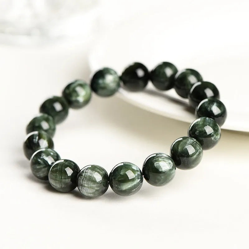 Green Dragon Crystal round bead bracelet with Ruyi design elements on a wrist.