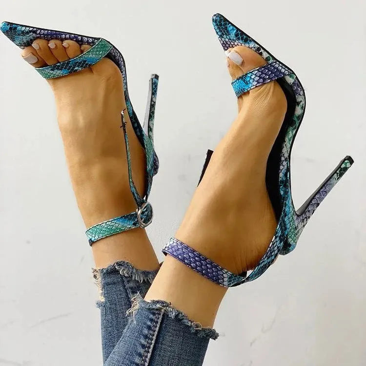 Blue women's high heels with serpentine hollow-out design and a buckle fastening on the ankle strap.