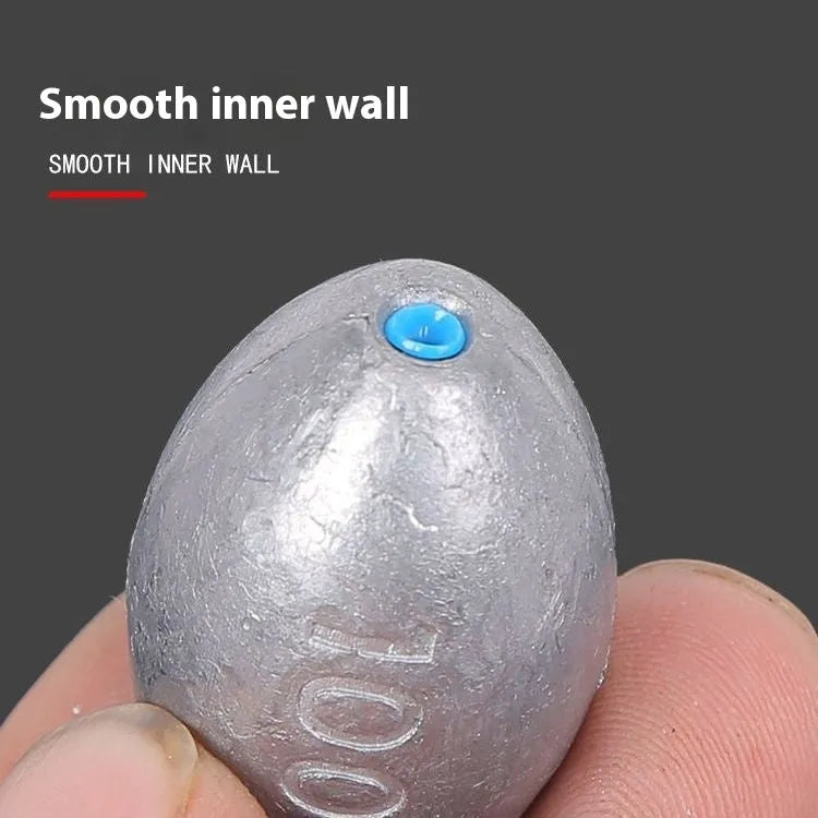 Olive lead fishing sinker with scale pattern showing rugby shape and plastic core construction