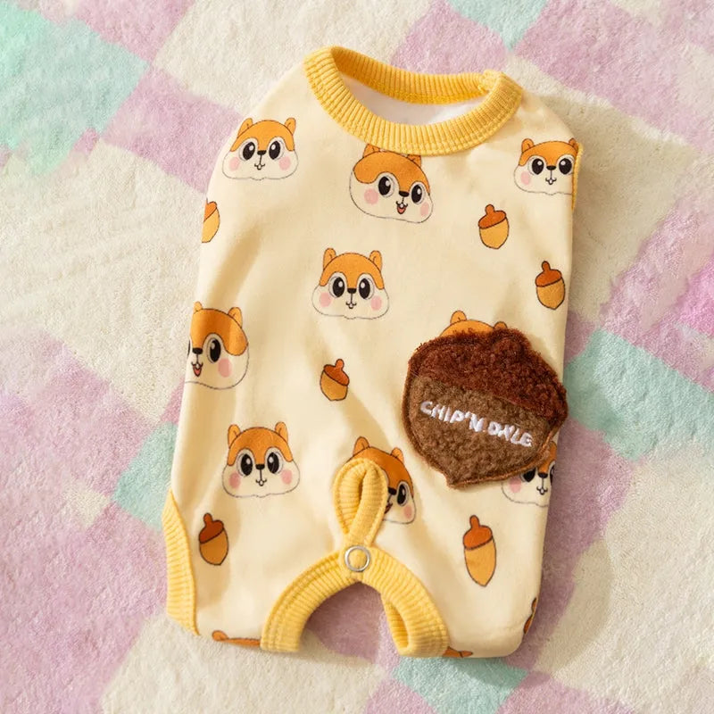 Chip 'n' Dale sleeveless dog jumpsuit with squirrel and acorn print, fuzzy embroidered acorn pocket, ribbed cuffs and snap closure, cream or white.