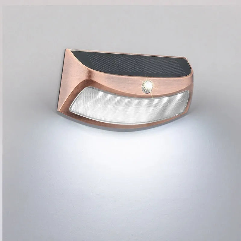 Solar-powered outdoor wall lamp with smiling face design for garden lighting