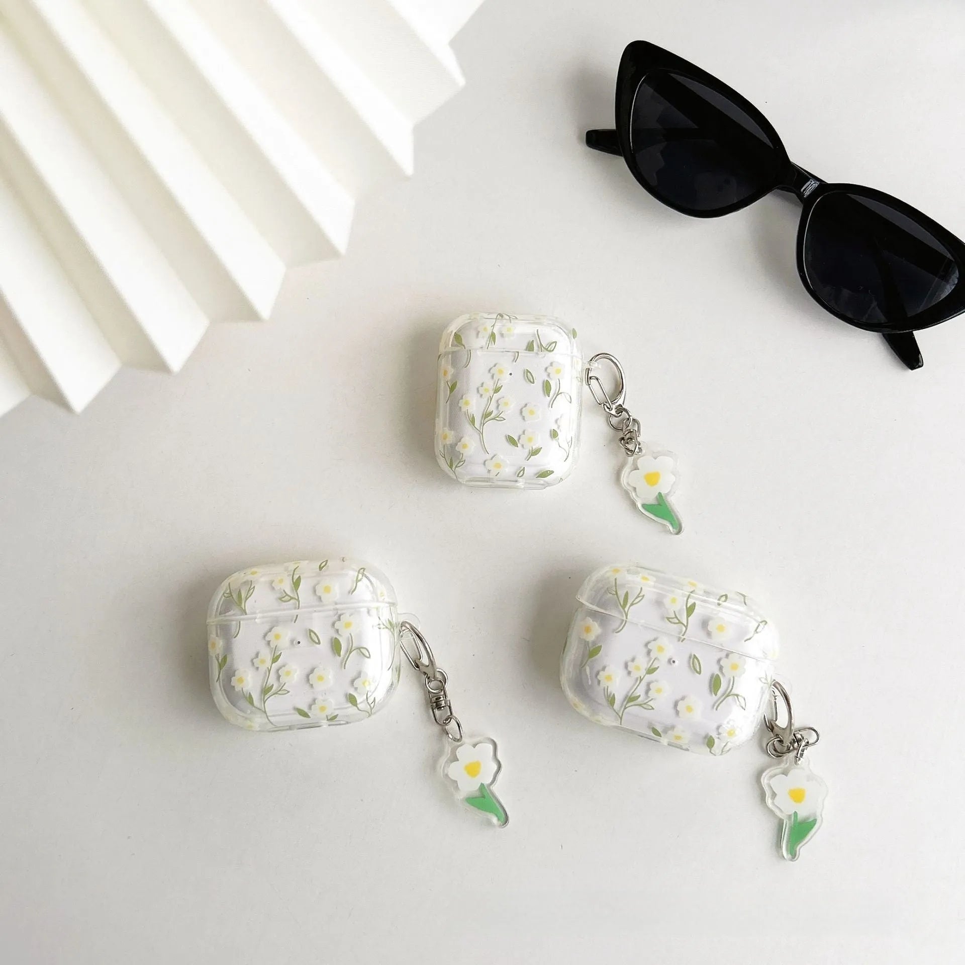 White floral high-transparent TPU protective cover for Apple AirPods on a table