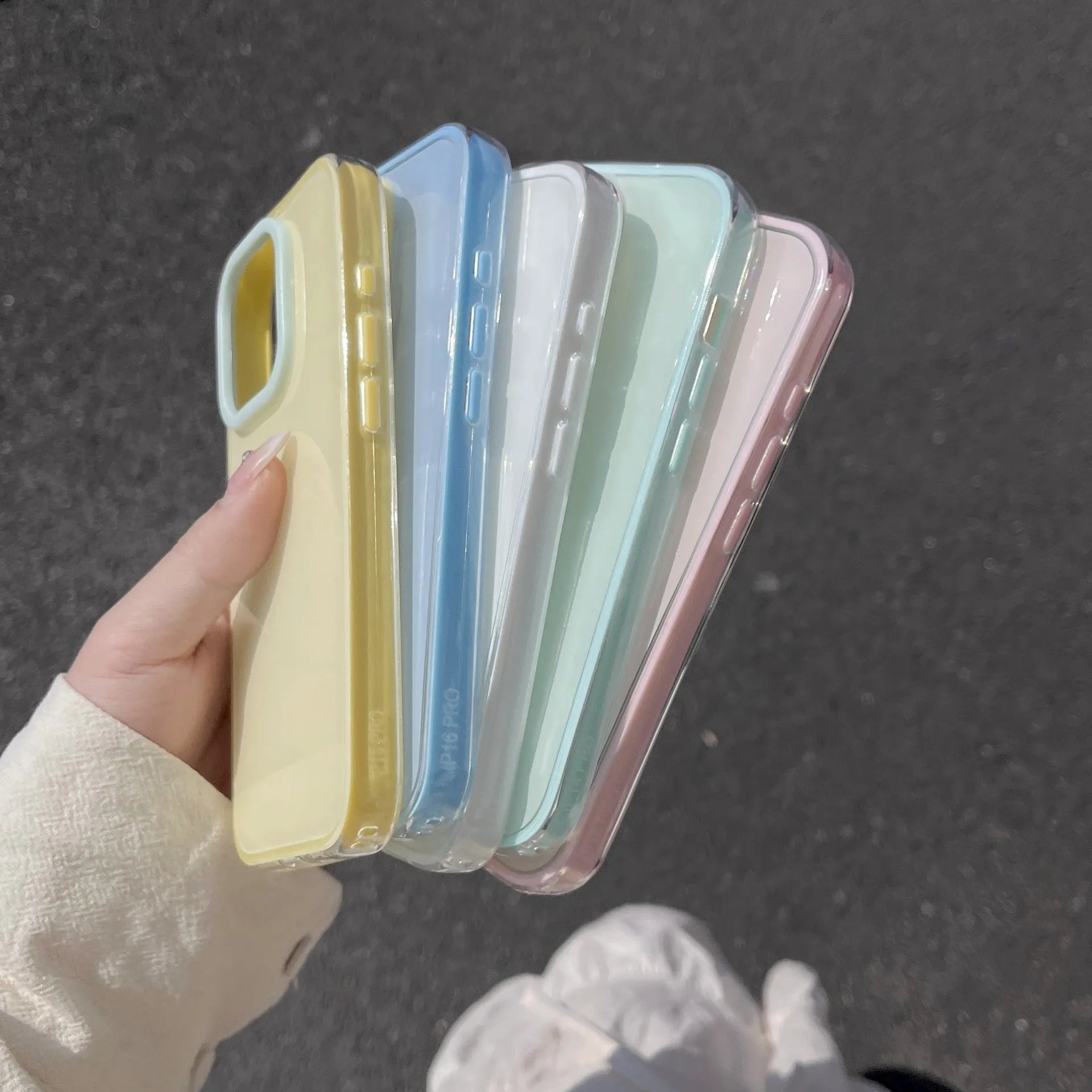 Simple solid colour jelly TPU phone case for iPhone, shown in blue, white and yellow.
