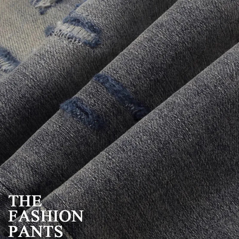 Men's slim fit distressed jeans with embroidered patches in old colour wash