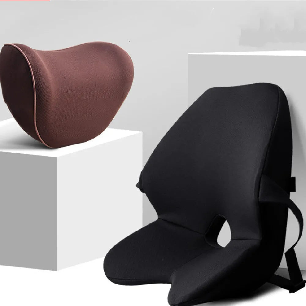 Black memory foam car lumbar support cushion with elastic straps, shown on a grey car seat.