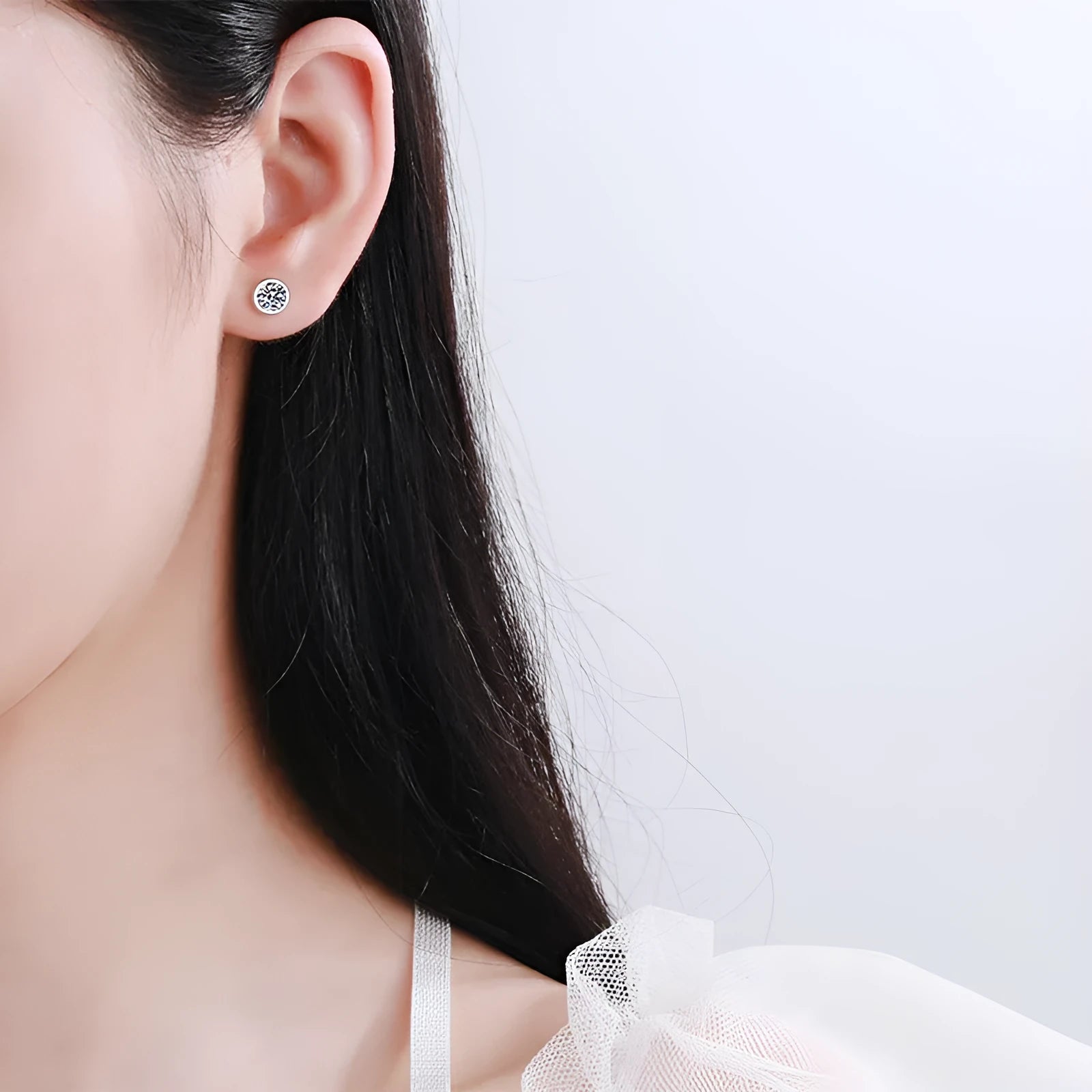 Gold-plated geometrical stud earrings with moissanite or zircon stone on a white background.