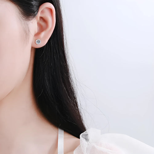 Gold-plated geometrical stud earrings with moissanite or zircon stone on a white background.