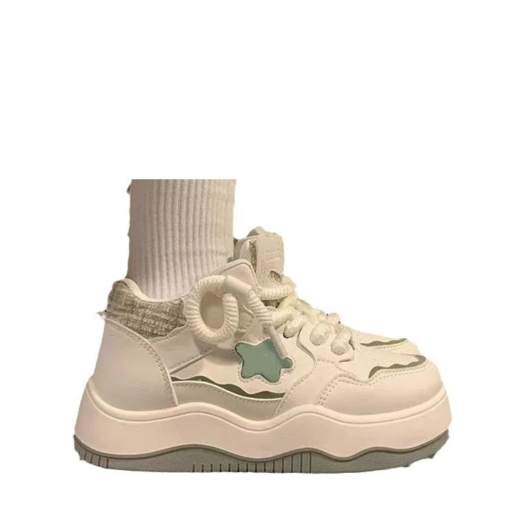 Women's green patent leather platform sneaker with lace-up front and round toe design on rubber sole