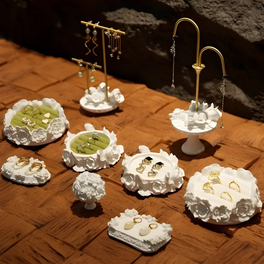 White gypsum rose ring storage tray with five style options shows a rose-shaped holder on a table