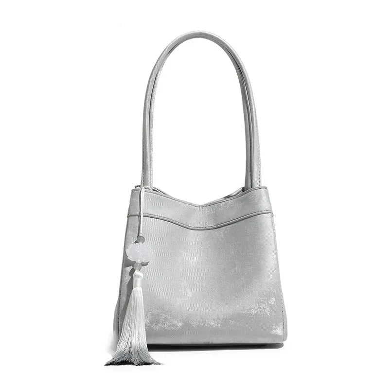 PU leather shoulder crossbody bag with single strap, tassel, open pocket, and sewing thread detail