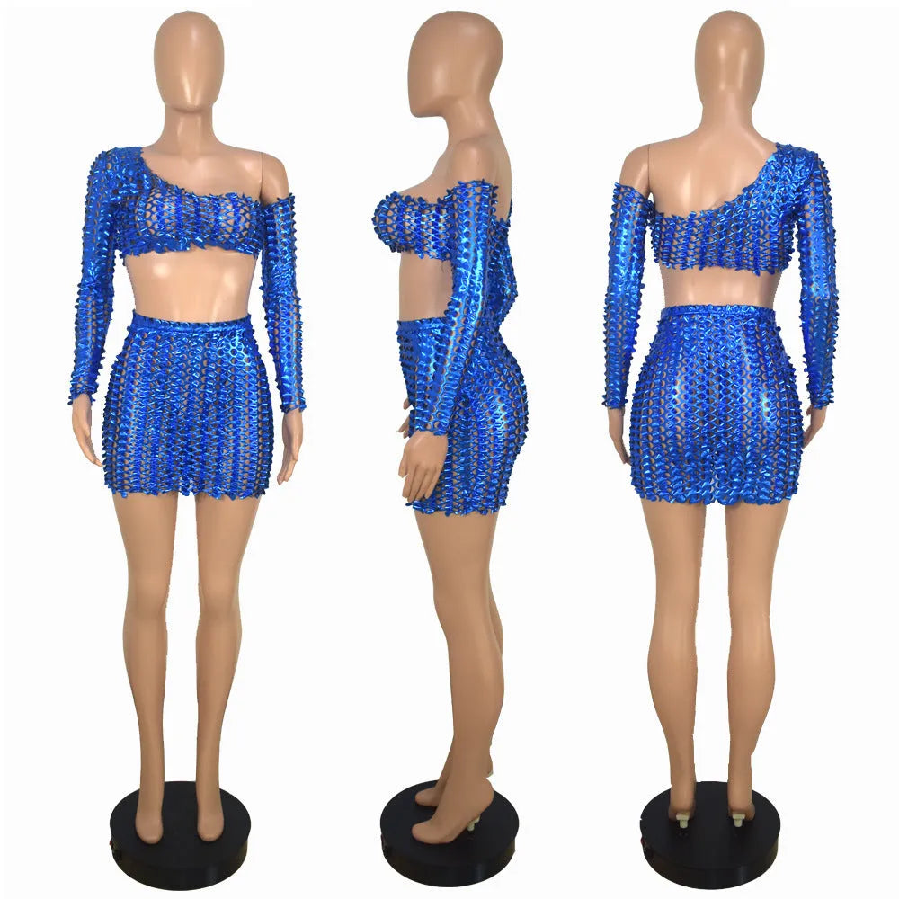 Women's black hollow-out net two-piece dress set with sleeveless top and short skirt on a hanger.