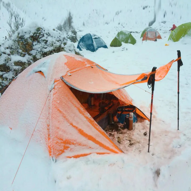 Blue double camping tent with aluminium poles set up outdoors for anti-storm protection