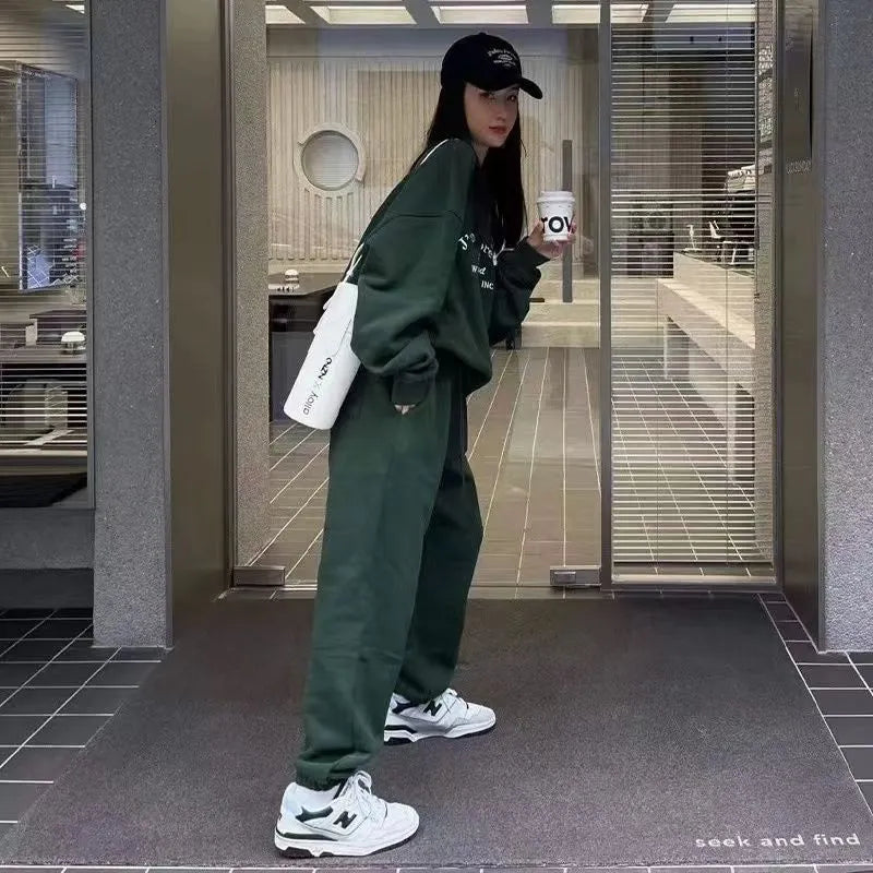 Women's cotton green American-style long-sleeved casual sportswear suit with trousers on a model