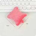 Plush wrist protector mouse pad in blue, green, and pink colours on a desk.