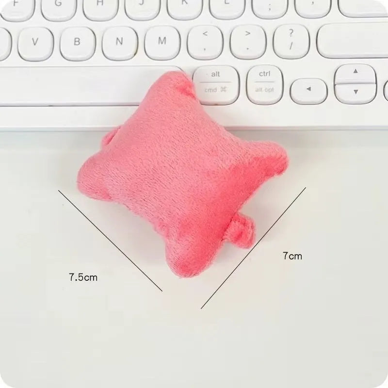 Plush wrist protector mouse pad in blue, green, and pink colours on a desk.