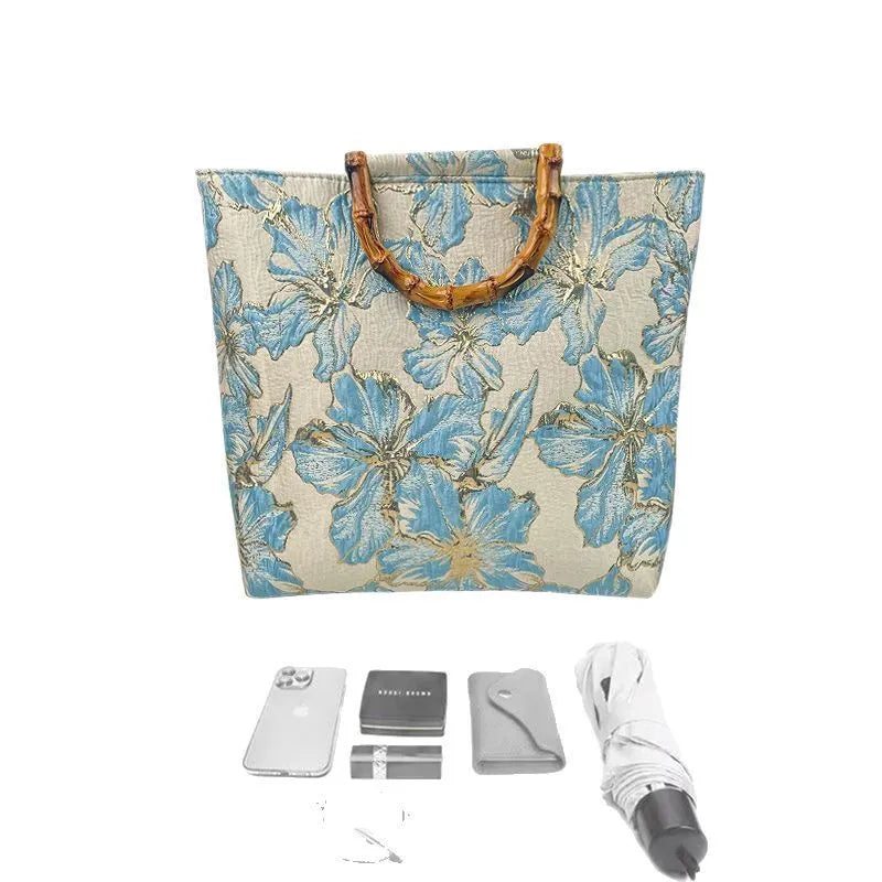 Light blue square canvas shoulder bag with bronzing flower detail and double strap connectors