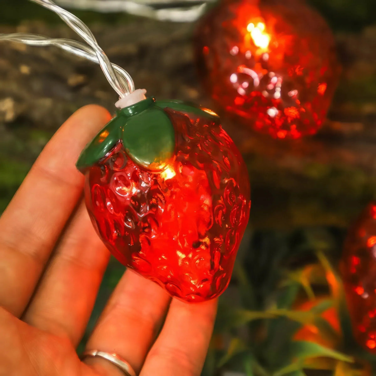 Warm strawberry-shaped LED string lights with IP66 protection, available in lengths from 1.5 m to 22 m.
