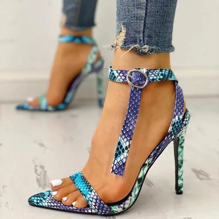 Blue women's high heels with serpentine hollow-out design and a buckle fastening on the ankle strap.