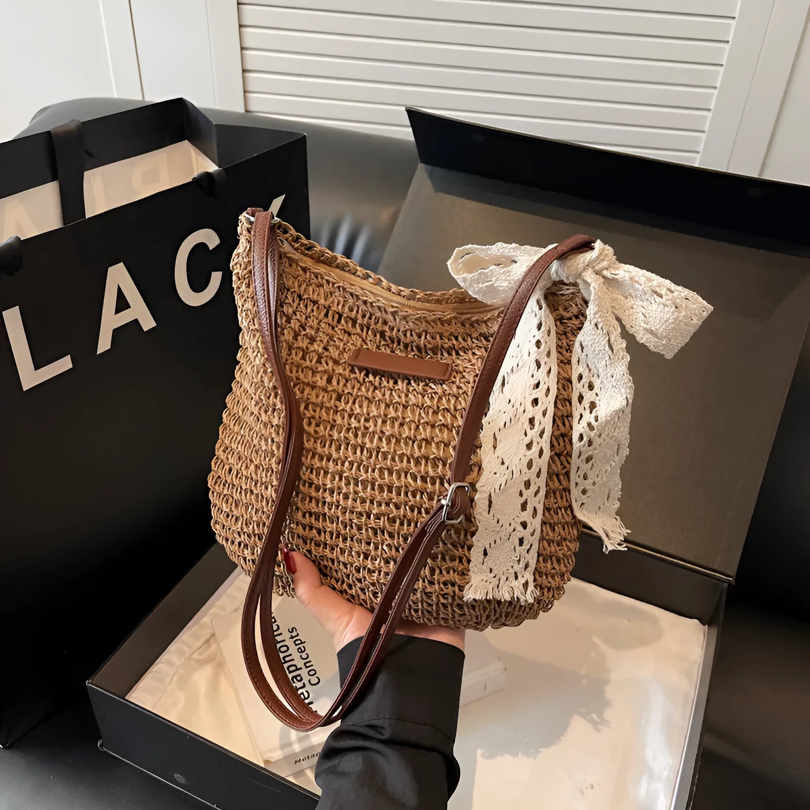 Women's straw woven messenger bag with hollowed design in khaki colour showing square shape