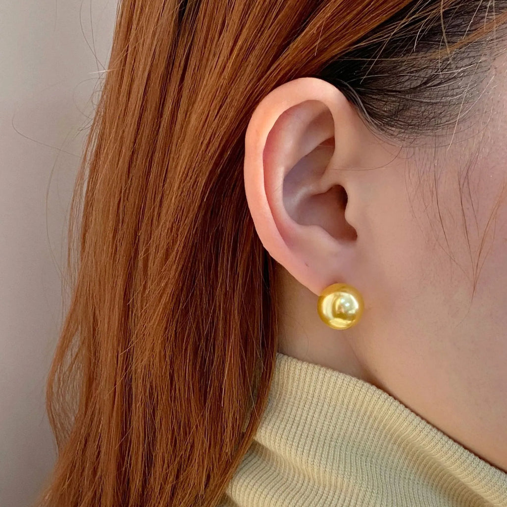 Retro-style geometric pearl stud earrings with star charms on silver settings