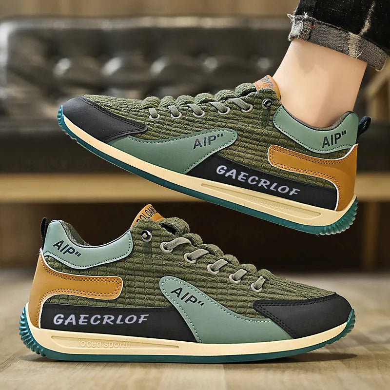 Men's grey and green mesh sports trainers with lace-up front and round toe.