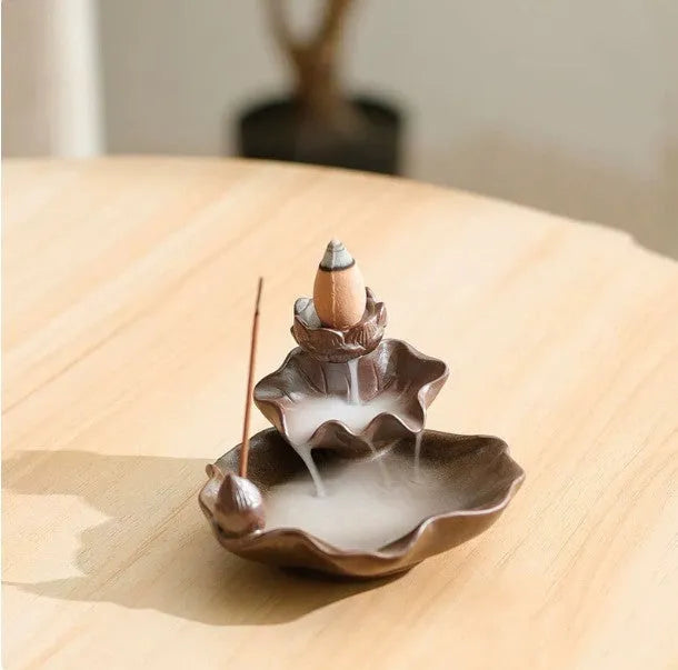 Square purple clay ceramic reverse flow incense burner with lotus and plum blossom decoration.