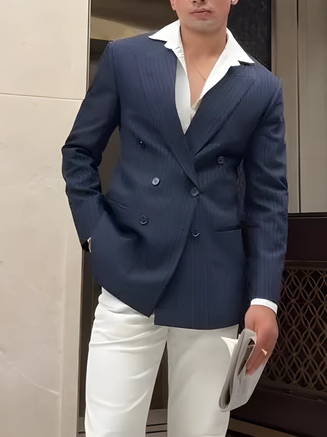 Men's striped double-breasted blazer showing regular fit and traditional tailoring details