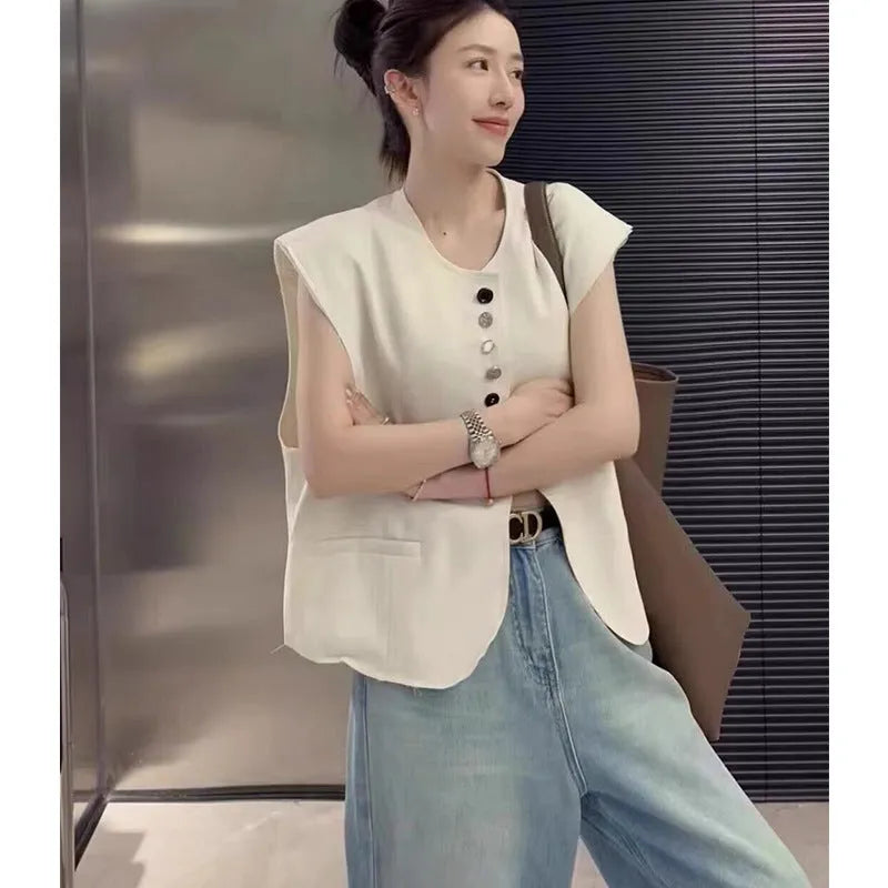 Women's loose fit polyester vest in milky white, showing front view with pockets.
