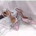 Women's black stiletto heel sandals with a silk back bandage and buckle closure.