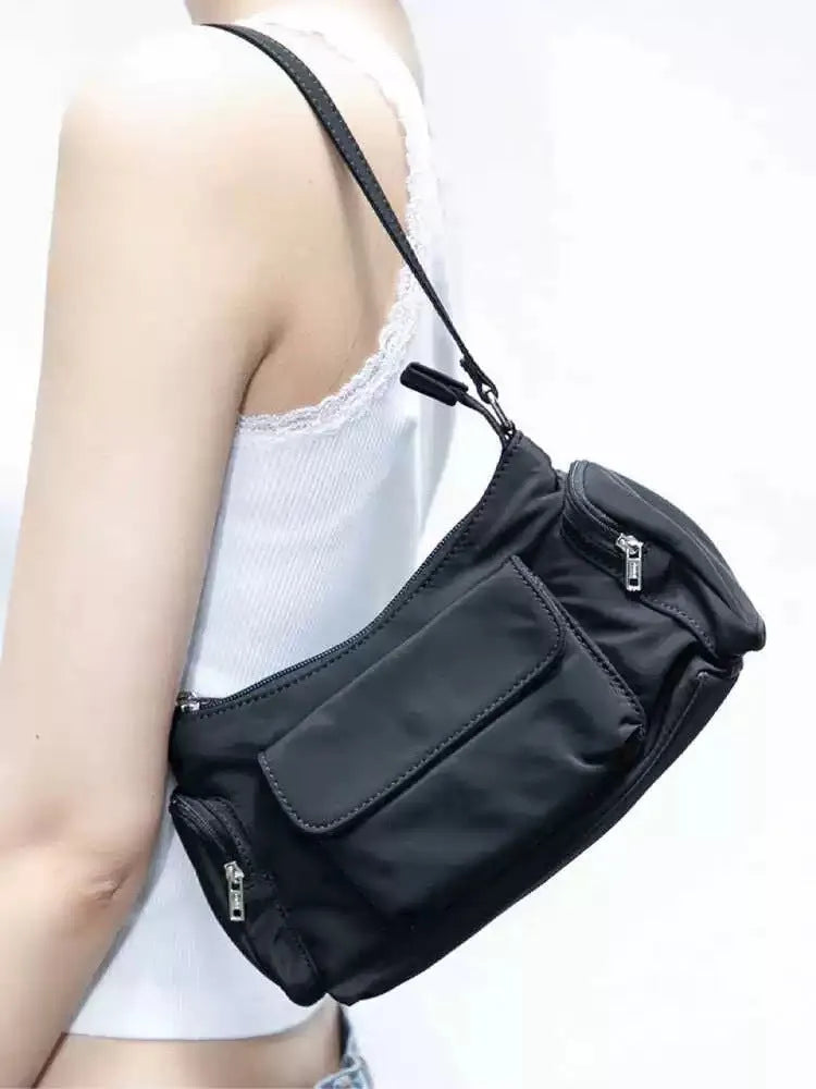 Black lightweight women's shoulder bag with double pockets showing side line detailing