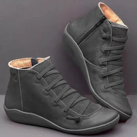 Women's casual ankle booties with a wedge heel and round toe in a selection of colours including black and leopard print.