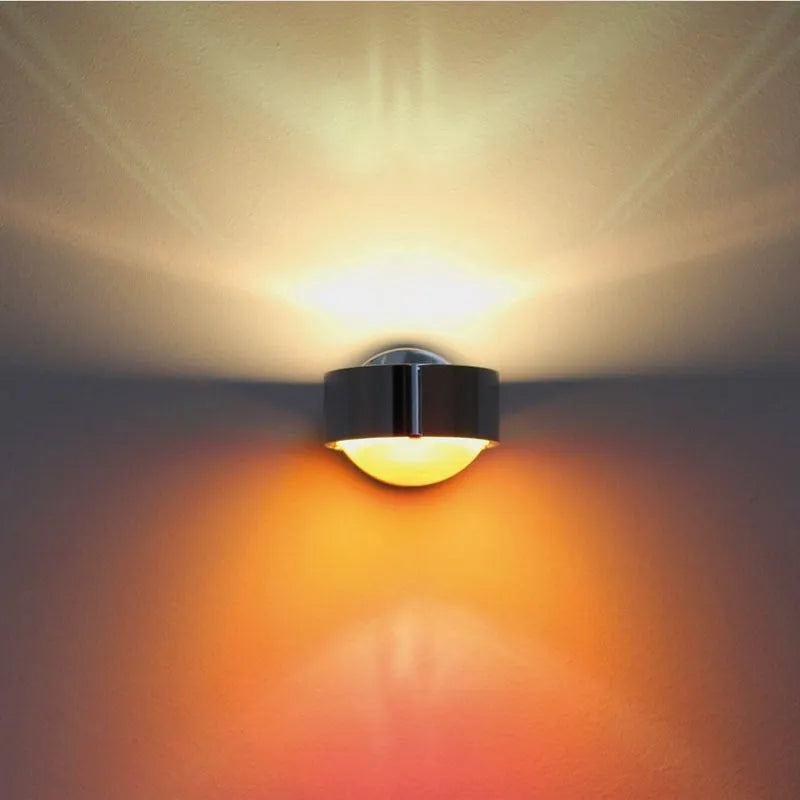 Modern small wall lamp in chrome finish for bedside or hallway lighting