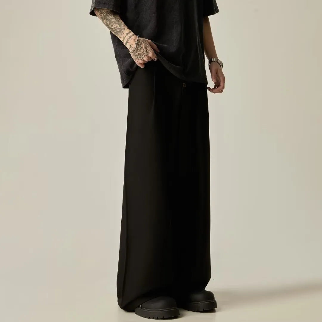 Men's black casual trousers with wide-leg design and button fly closure showing elastic waistband detail
