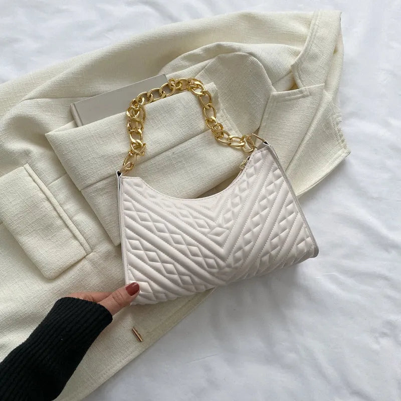 Brown pleated chain shoulder bag with soft handle and adjustable strap showing sewing line detailing