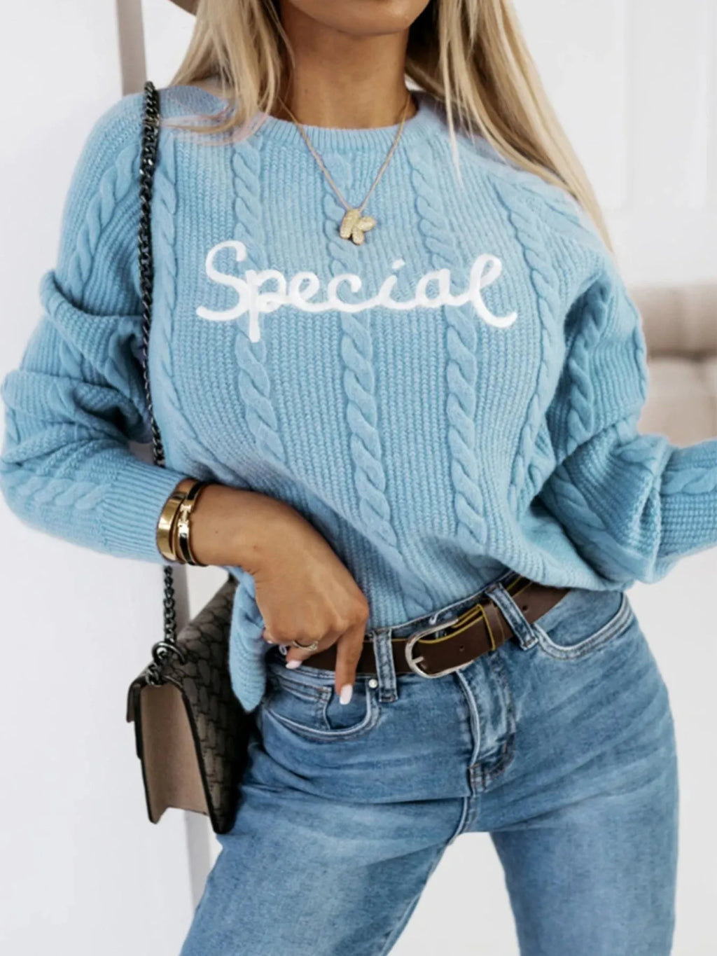 Blue crew neck knitwear pullover sweater with embroidered white letter and text patterns on the front