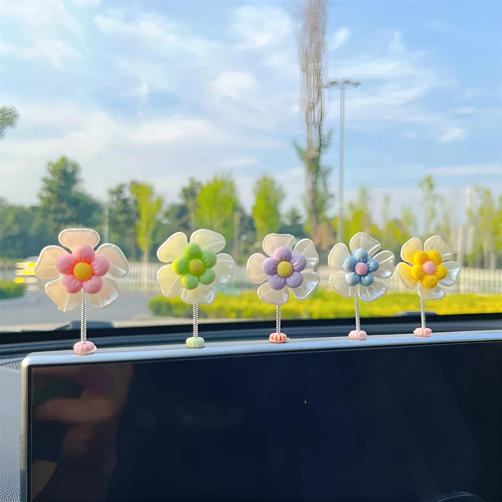 Coloured plastic car decoration swing ornament measuring approximately 5cm by 3.5cm