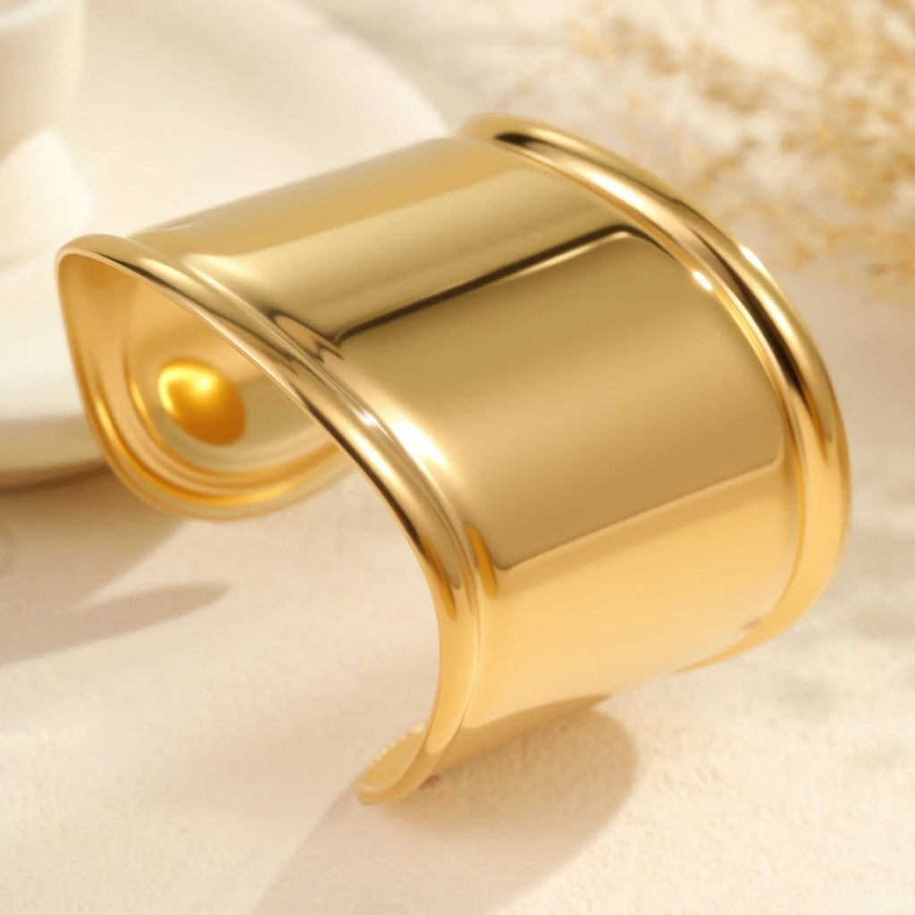 Women's wide fashion bracelet with geometric wave design in gold plating on stainless steel