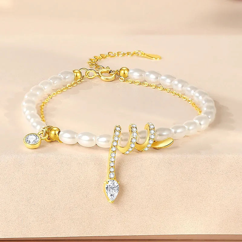 Pearl snake 925 sterling silver bracelet with geometric design in gold or white gold finish.