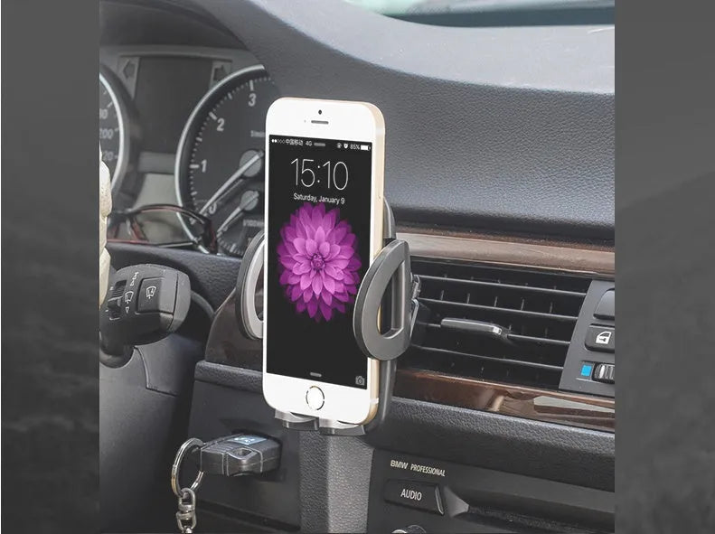 Black plastic mobile phone holder attached to car air conditioning vent