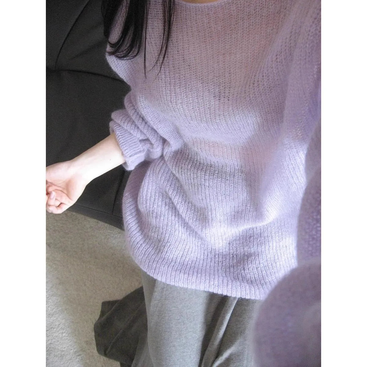 Purple women's round neck blouse with hollow-out detail and princess sleeves on a hanger.