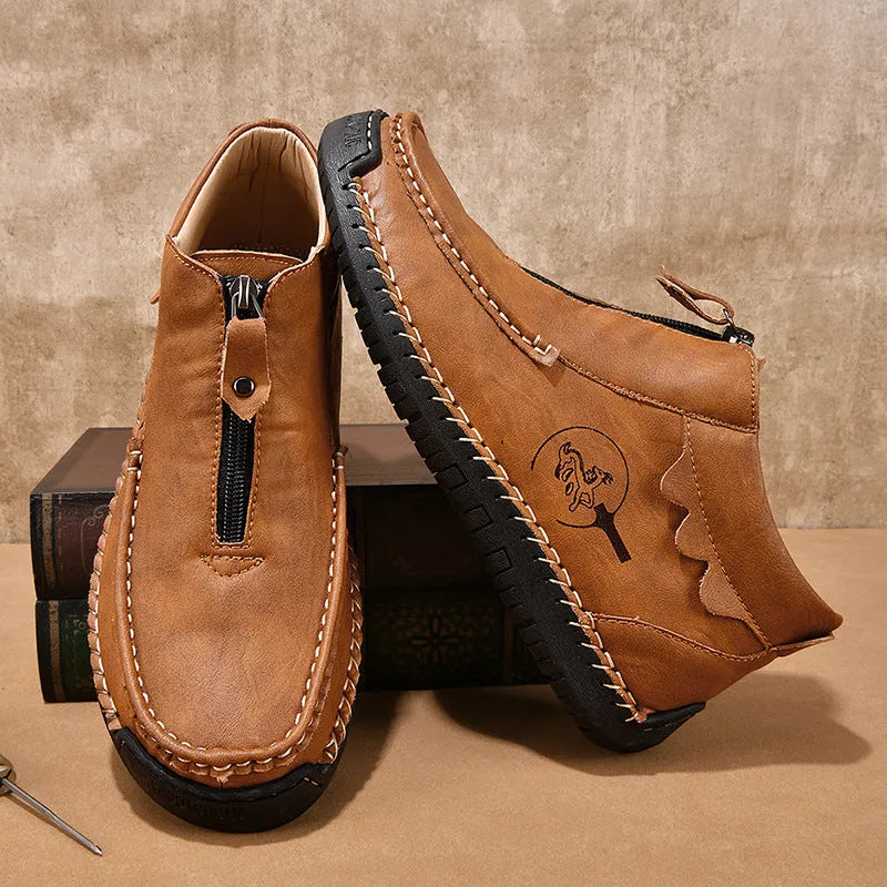 Men's brown slip-on leather loafers with round toe and rubber sole shown from side view