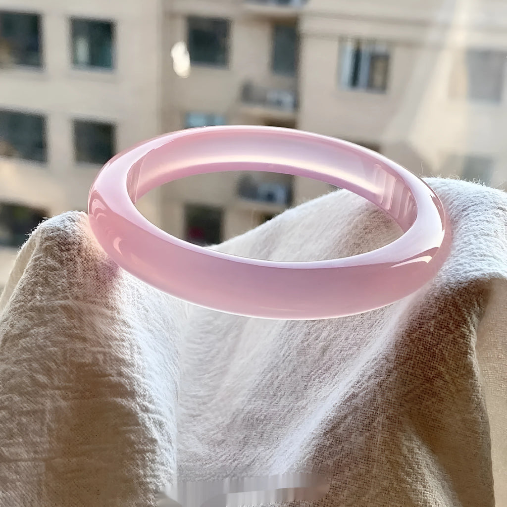 Natural agate wide tire bracelet shown in various colours including pink, blue, green and white agate.