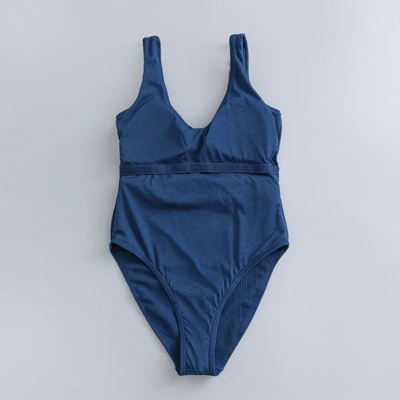 Navy blue women's one-piece swimsuit with triangular chest shape and integrated chest pads