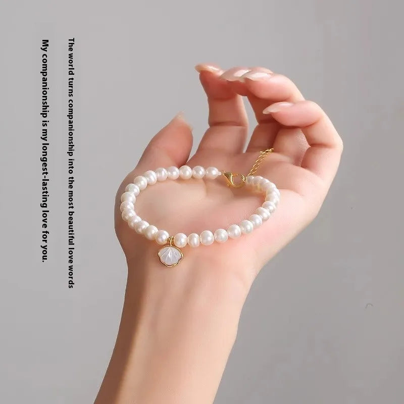 Freshwater pearl bracelet with fan-shaped pearl arrangement showing elastic string and extension chain fastening options