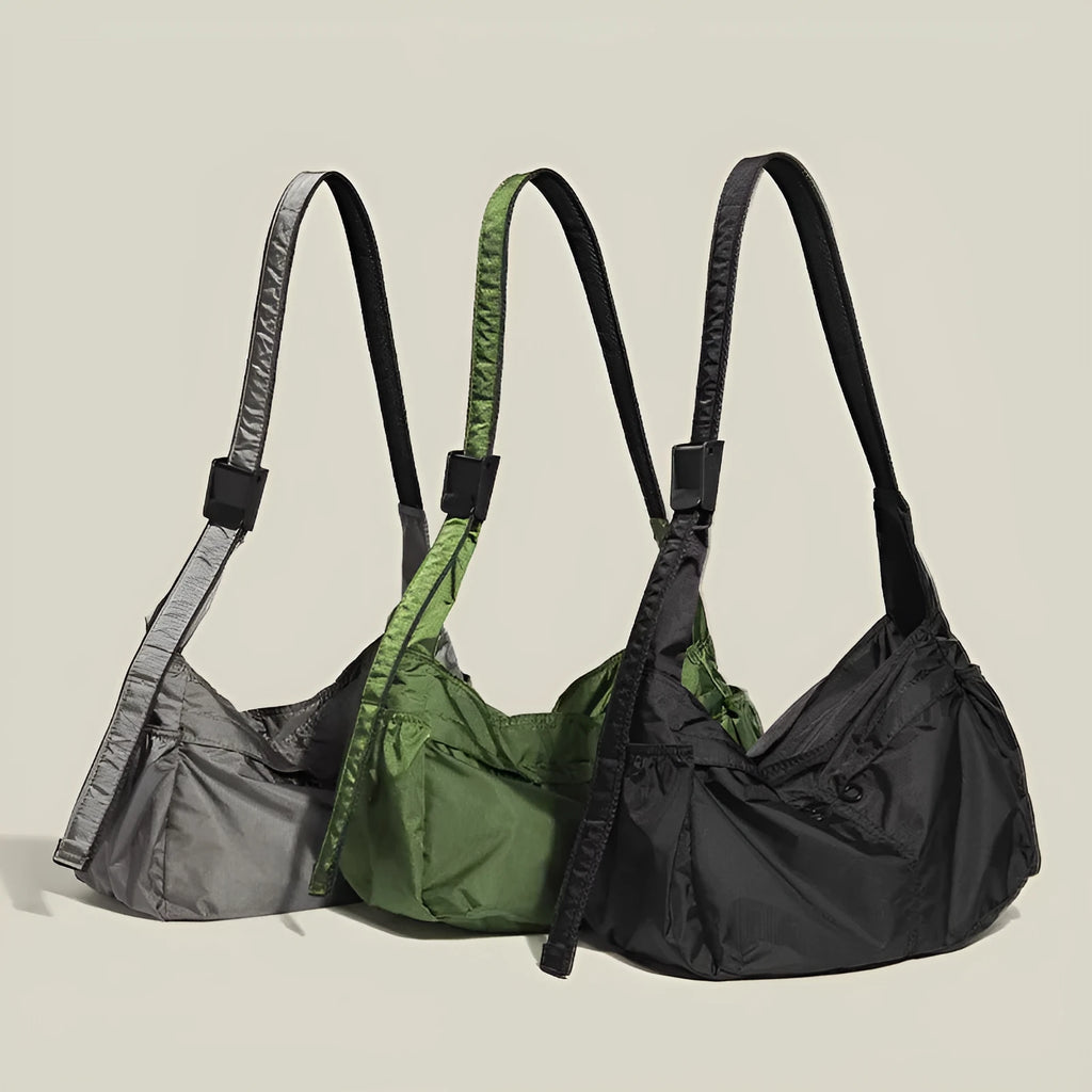 Waterproof nylon messenger bag in black colour showing horizontal square shape and shoulder strap